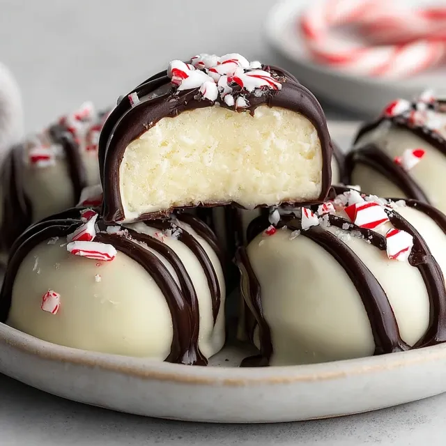 Quick Christmas peppermint creams with creamy mint filling, coated in white chocolate and dark chocolate drizzle, topped with crushed candy canes.