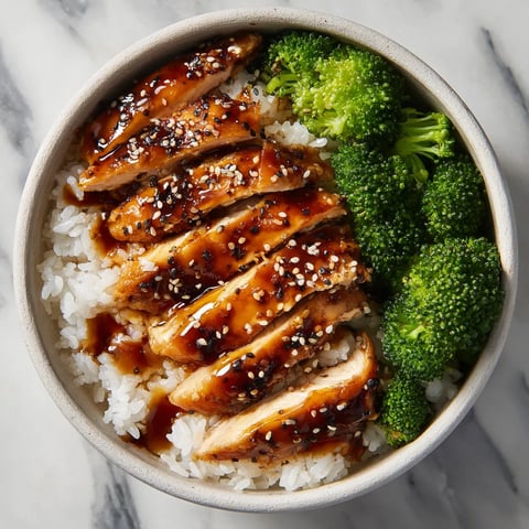 A bowl of food with rice and broccoli.